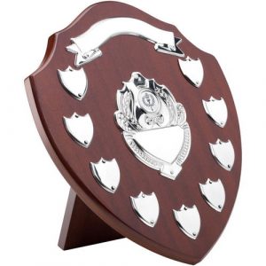 MAHOGANY SHIELD WITH CHROME FRONTS AND 9 RECORD SHIELDS (1in CENTRE) – 12.75in